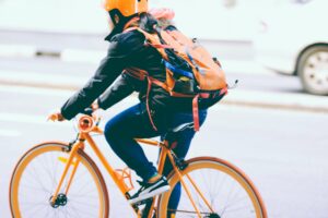 close up cyclist on orange bike