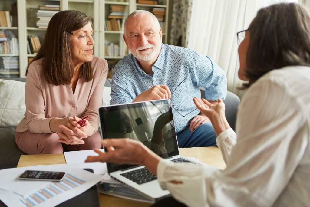 Senior couple discussing their retirement options with a consultant, exploring the best places to retire in Australia for their lifestyle needs.