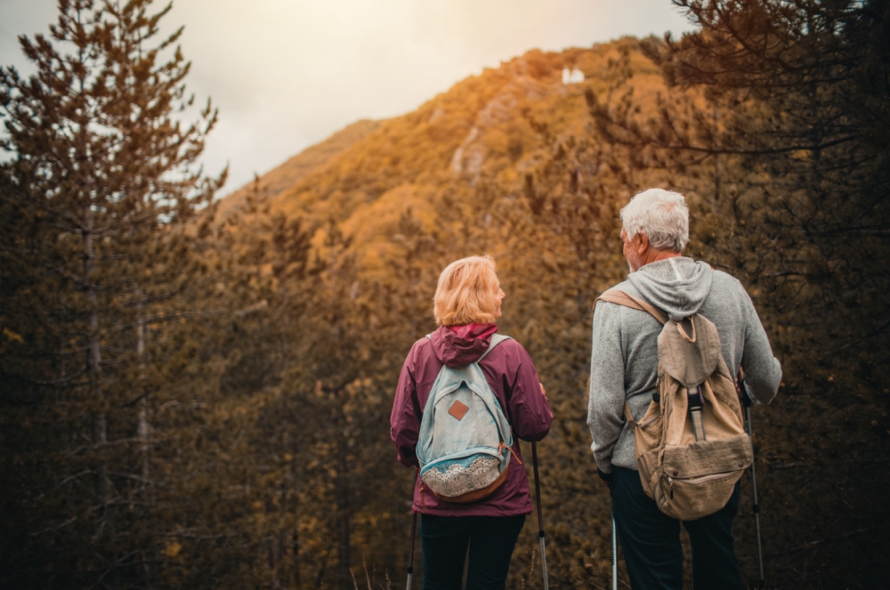 An active retired couple hiking through scenic trails, enjoying one of the best places to retire in Australia for outdoor lovers.