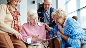 Seniors discussing downsizing while viewing a photo album.