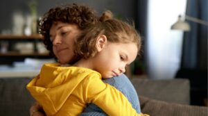 A mother comforting her concerned child about Cyclone Alfred, offering reassurance and guidance on storm preparedness in Queensland.