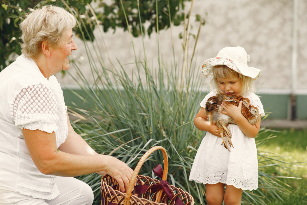 Grandmother and grandchild in a family garden, showing the emotional connection seniors have to home and memories
