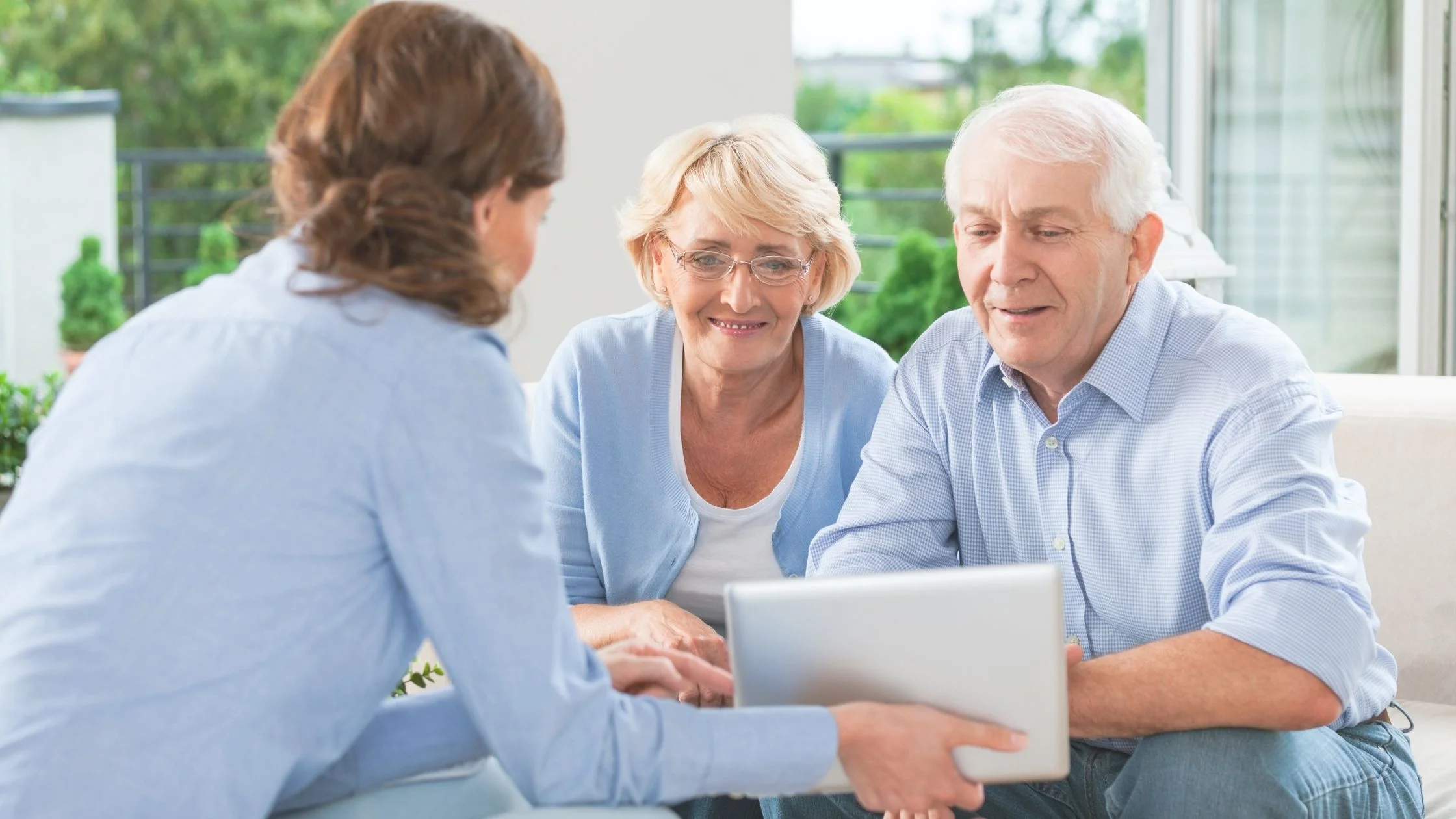 Retired couple reviewing bills and budgeting for retirement costs